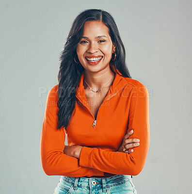 Buy stock photo Portrait of smiling mixed race woman isolated on grey studio background with copyspace with arms crossed. Beautiful happy young hispanic standing alone with arms folded. One model feeling confident