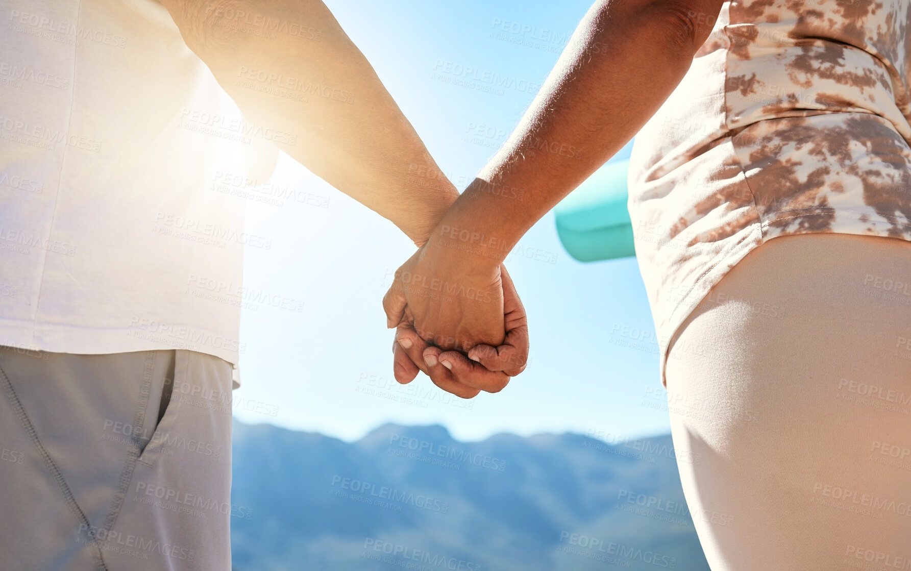 Buy stock photo Couple, holding hands and love for travel on mountain with sightseeing, view of nature or scenery. Closeup, people and relax together on cliff for romance, relationship or support on vacation holiday