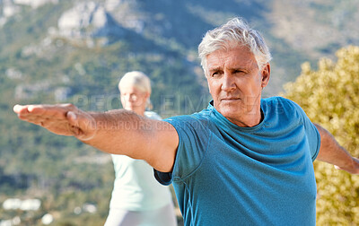 Buy stock photo Seniors living a healthy lifestyle and exercising outdoors. Senior couple standing in warrior pose while practicing yoga in nature on a sunny day