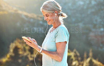 Buy stock photo Senior, happy woman and listening with earphones on mountain for music or audio streaming in nature. Mature, female person or yogi with smile or headphones on mobile smartphone for audio podcast