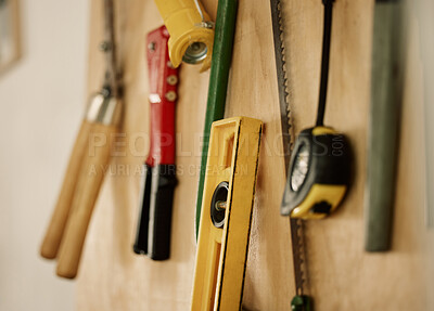 Buy stock photo A collection of assorted tools and equipment on a wall. Tools and equipment on a wall. Maintenance tools hanging on wooden wall. Neat, organised manufacturing tools. Still life of tools
