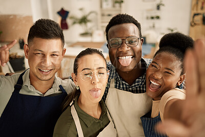 Buy stock photo Diverse businesspeople being silly in a selfie. Group of fashion designers taking a selfie. Tailors making funny facial expressions in a photo. Happy colleagues taking a selfie at work