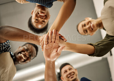 Buy stock photo Diverse businesspeople hands stacked from below. Group of fashion designers celebrating and motivating each other. Tailors huddled with hands piled. Group of designers having fun with hands stacked