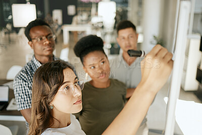 Buy stock photo Mixed race coach mentor writing on board explaining idea and thoughts while brainstorming with colleagues. Diverse colleagues discussing ideas while collaborating on project