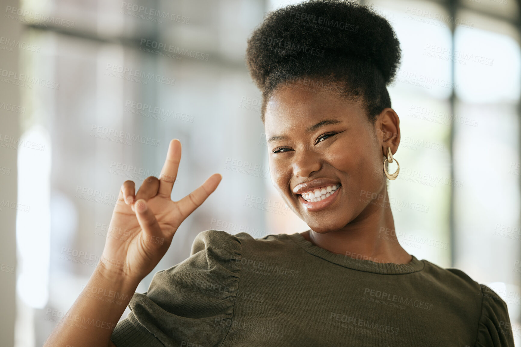 Buy stock photo Happy optimistic african american business woman gesturing peace. Playful young female entrepreneur showing victory sign in an office