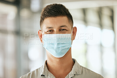 Buy stock photo Portrait of business man wearing protective face mask in the office for safety and protection during COVID-19. Happy hispanic male entrepreneur with mask at workplace