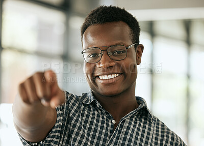 Buy stock photo Portrait of a confident young professional african american business man with glasses pointing index finger at camera while standing in an office. HR manager choosing you