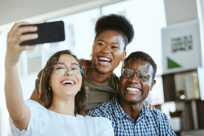 Buy stock photo Group of young cheerful businesspeople taking a selfie together at work. Happy hispanic businesswoman taking a photo with her colleagues on her phone in an office