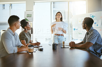 Group of diverse businesspeople having a meeting in an office at work. Happy mixed race businesswoman talking while doing a presentation at a table for coworkers. Businesspeople planning together