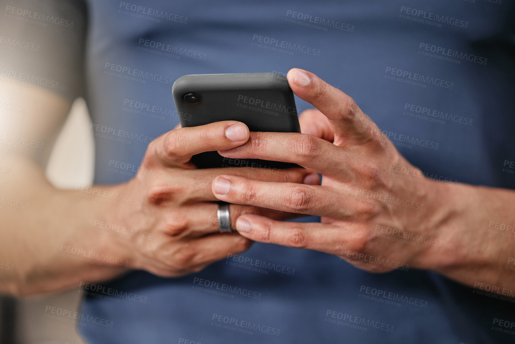 Buy stock photo Closeup of one active caucasian man texting on cellphone with while on break from exercise in a gym. Male athlete browsing fitness apps, social media and watching workout tutorials online