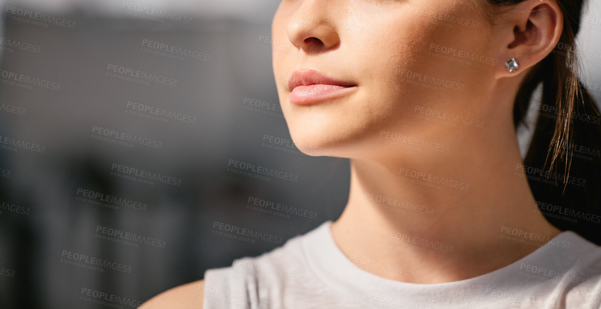 Buy stock photo Closeup of one focused caucasian woman exercising in a gym with copyspace on the side. Face of a determined and motivated female athlete with healthy skin looking thoughtful in a fitness centre