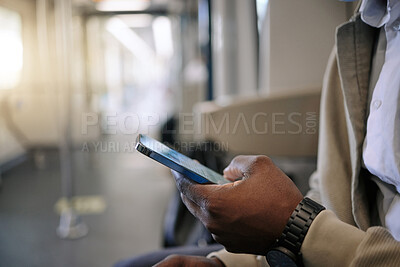 Buy stock photo Closeup of Black businessman travelling in a train while using a cellphone. African american male using a wireless device while commuting on a train