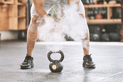 Buy stock photo Dusting before power lifting. Bodybuilder getting ready to lift a heavy kettlebell. Athlete ready to lift weights. Sporty, muscular trainer using powder before a weight lifting routine.