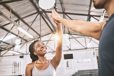 Buy stock photo Happy friends high five after a workout. Young trainer motivating his client to exercise. African American woman giving her trainer a high five. Friends celebrate after a workout class