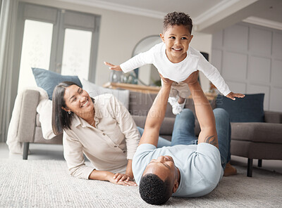 Buy stock photo Happy, airplane and family in their home, play or bonding with happiness, loving or fun in a living room. Parents, mother or father with male kid, son or boy with games, fly or cheerful in the lounge