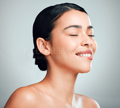 Buy stock photo A beautiful young mixed race woman with glowing skin posing against grey copyspace background. Hispanic woman with natural glowing skin looking flirty and sexy in a studio