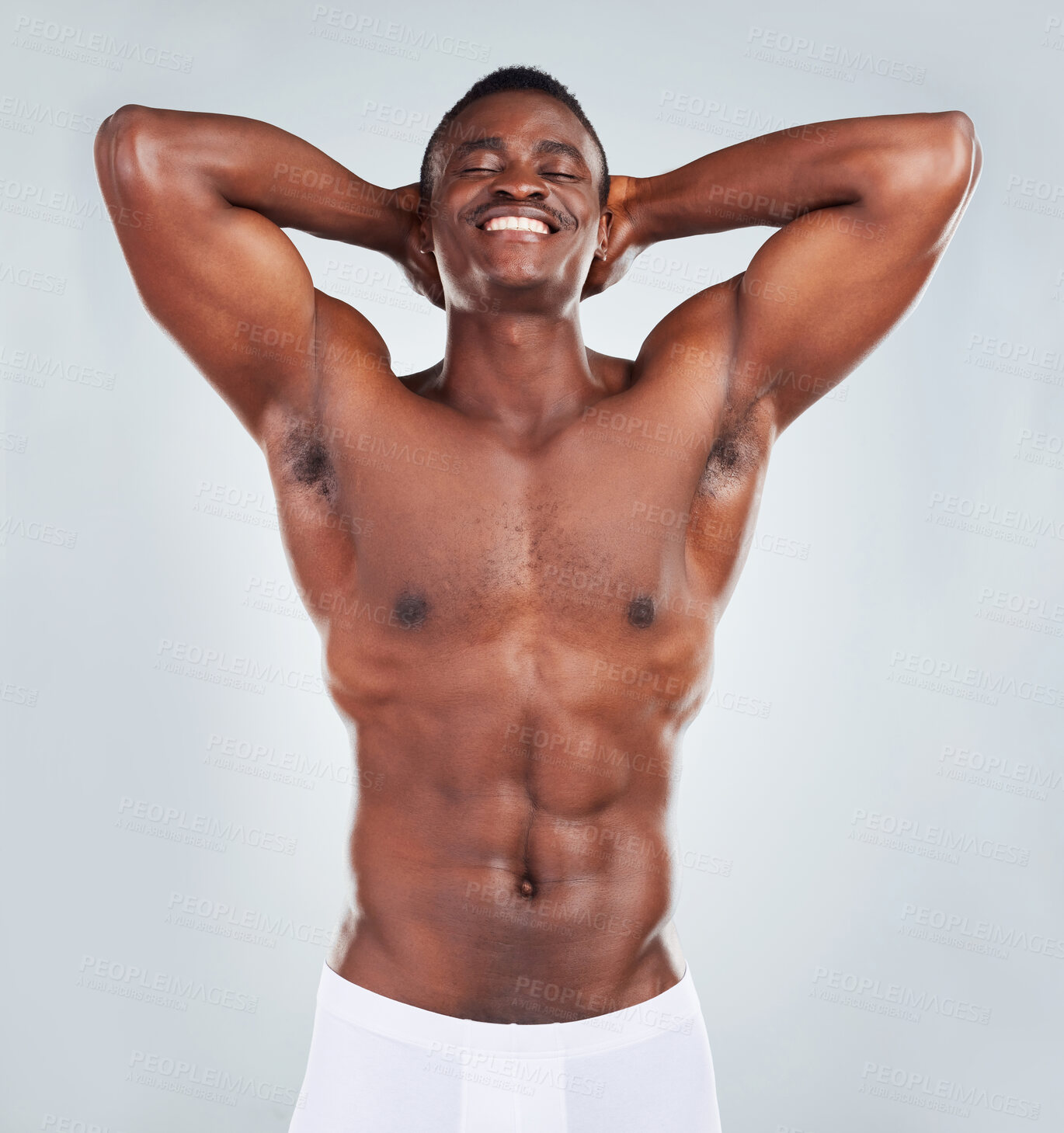Buy stock photo Portrait of a smiling African American fitness model posing topless in a underwear and looking muscular. Happy black male athlete isolated on grey copyspace in a studio wearing boxers
