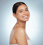 Portrait of a beautiful woman with smooth glowing skin and copyspace posing. Headshot of a smiling caucasian model isolated against a grey studio background. Young woman with healthy skincare routine