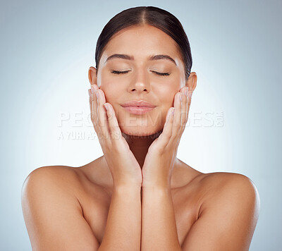 Buy stock photo Beautiful woman with smooth glowing skin and copyspace posing topless and touching her face. Confident caucasian model isolated against a grey studio background. Healthy skincare and self care routine