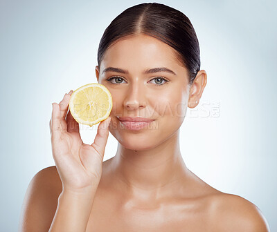 Buy stock photo Face, skincare and woman with lemon in studio isolated on a white background. Portrait, natural or female model with fruit for vitamin c, vegan nutrition or healthy diet, wellness or beauty cosmetics