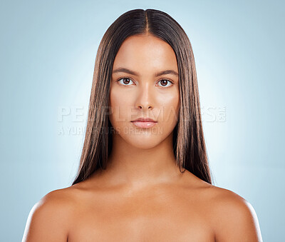 Buy stock photo Portrait of a hispanic brunette woman with long lush beautiful hair posing against a grey studio background. Mixed race female standing showing her beautiful healthy hair