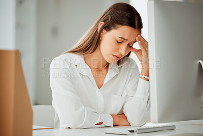 Buy stock photo One anxious young hispanic business woman suffering with a headache while working on a computer in an office. Entrepreneur feeling overworked, tired and anxious about deadlines. Mentally frustrated with burnout and stress