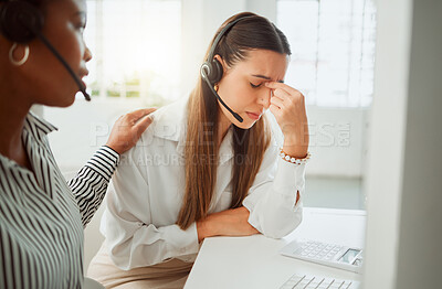 Buy stock photo Stressed young hispanic call centre agent looking worried and suffering with headache while being comforted and consoled by a colleague in an office. Woman offering sympathy and support to frustrated and upset coworker