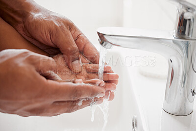Buy stock photo An unknown mixed race father and daughter washing their hands  together in a bathroom at home. Unrecognizable single African American parent teaching his daughter about hygiene