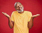 Mature african american man with a beard shrugging his shoulders and making a gesture with his hands standing against a red studio background. Uncertain, decision, choice
