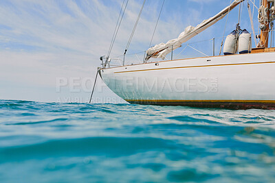 Empty boat docked on the ocean in open water. Boat anchored in the ocean on a sunny day after a sailing cruise.
