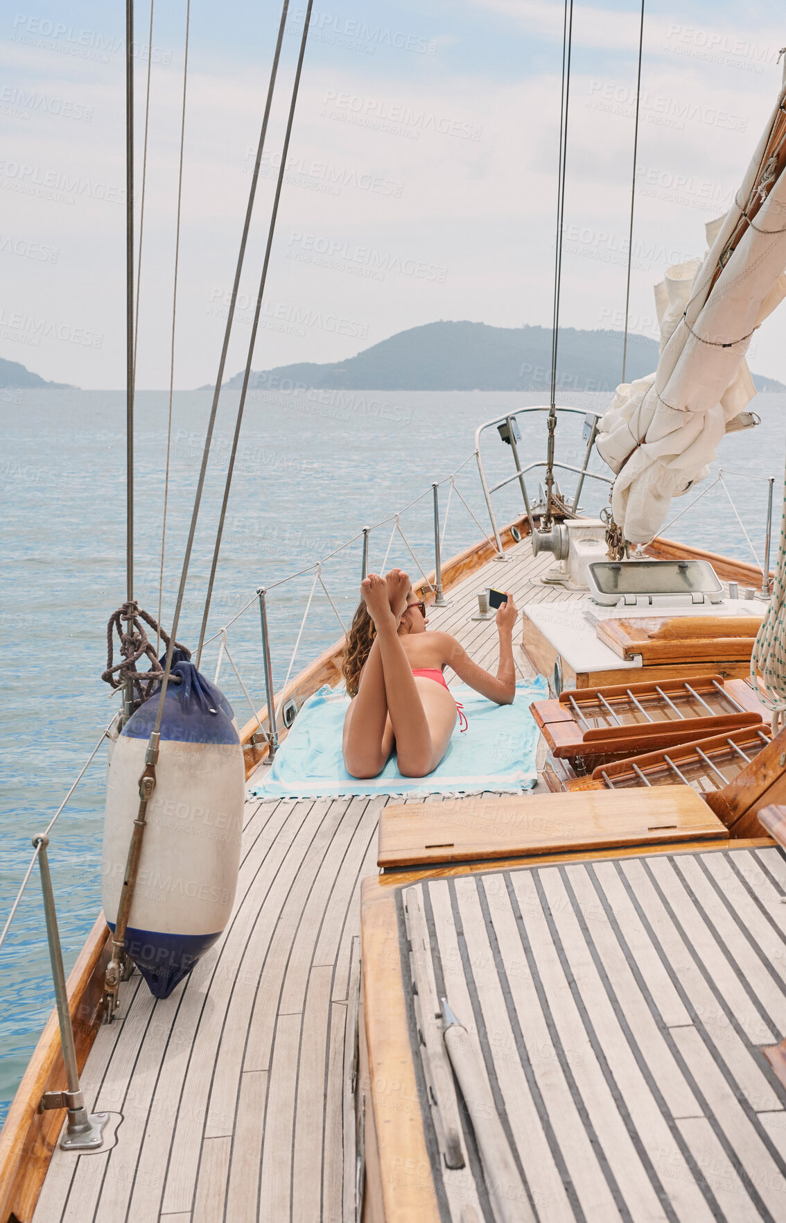 Buy stock photo Travel, yacht and women with phone on boat relax for cruise on holiday, vacation and adventure at sea. Luxury sailing, sunbathing and female person on smartphone for social media, memories and online