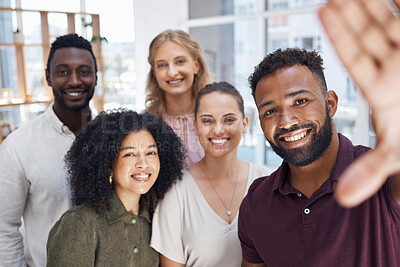Portrait of a group of five cheerful diverse businesspeople taking a selfie together at work. Happy mixed race businessman taking a photo with his joyful colleagues