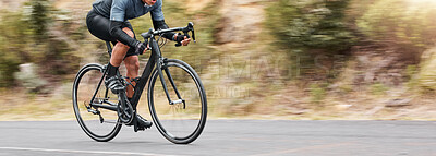 Buy stock photo Young man showing his cycling skills while out cycling on a bicycle outside. Adrenaline junkie practicing a speed racing outdoors. Unrecognizable male training for a marathon on a bike 