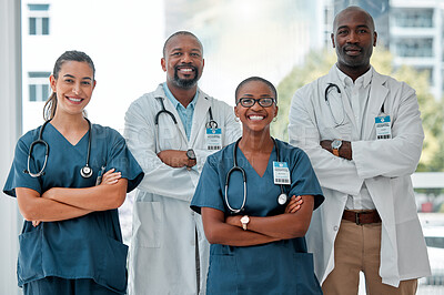 Group of happy diverse doctors and nurses standing in a line with their arms crossed while working at a hospital. Content expert medical professionals smiling at work together at a clinic