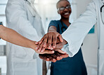 Group of diverse doctors stacking their hands together in support while working at a hospital. Medical professionals joining their hands in unity and motivation while working at a clinic