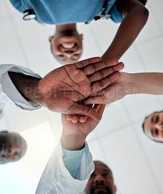 Buy stock photo Goal of a group of doctors with their hands together in support, unity and trust together ready for surgery in hospital. Below view of medical team or healthcare professionals winning and celebrating
