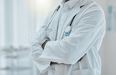 Buy stock photo Proud doctor standing with their arms crossed while working at a hospital alone. One expert medical professional standing while at work at a clinic