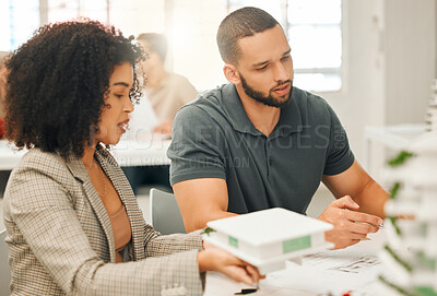 Buy stock photo Young designers working on 3D model. Creative professionals brainstorm and collaborate. Professional architects working on a building project together. Focused businesspeople planning together