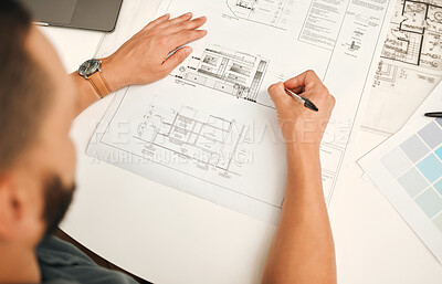 Buy stock photo Businessman writing on a building blueprint. Architect planning a building project from above. Creative designer working on a building project. Businessman sketching a blueprint