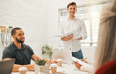 Buy stock photo Cheerful businessman giving a presentation. Smiling architect using a report in a meeting. Colleagues collaborating in meeting. Corporate professional talking to coworkers,holding a document