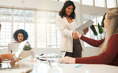 Buy stock photo Two businesswomen greeting with a handshake. Leading businesswoman shaking hands with a staff member. African american businesswoman handshake with colleague.Staff members in an interview