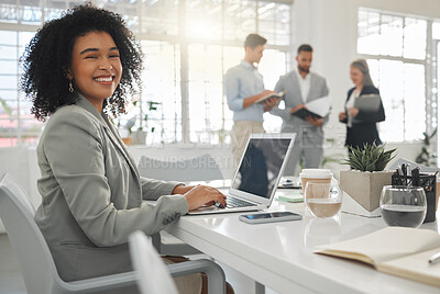 Buy stock photo Portrait of a cheerful mixed race businesswoman working on a laptop at work. Happy hispanic female businessperson with a curly afro typing en email on a laptop in an office