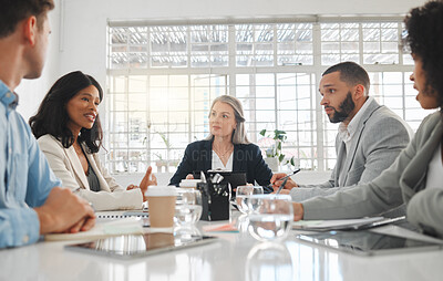 Buy stock photo Group of five diverse businesspeople talking in a meeting together at work. Business professionals talking and planning in an office. Young african american businesswoman discussing an idea with colleagues at a table