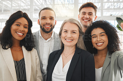 Portrait of a group of five cheerful diverse and positive businesspeople taking a selfie together at work. Young happy caucasian businessman taking a photo with his joyful colleagues