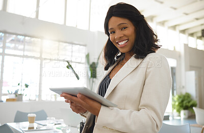 Buy stock photo Young happy african american businesswoman working on a digital tablet alone in an office. One confident black female boss smiling and holding a digital tablet at work