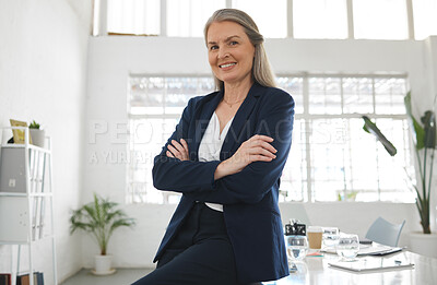 Buy stock photo Mature happy caucasian businesswoman standing with her arms crossed while in an office alone. One confident female manager smiling and standing at work
