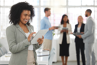 Buy stock photo Young happy mixed race businesswoman working on a digital tablet in an office. One joyful hispanic female boss with a curly afro holding and using social media on a digital tablet at work