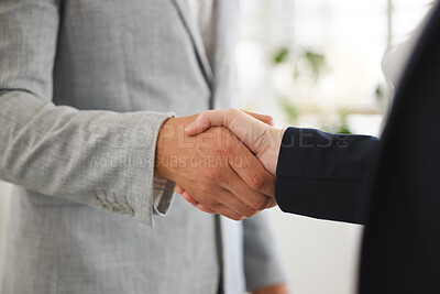 Buy stock photo Two businesspeople shaking hands while in an office together at work. Executive business professionals greeting networking and making deals with each other. Boss hiring an employee