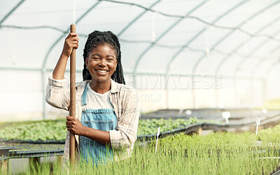 Buy stock photo Portrait of a happy woman working on a farm. Smiling farmer working in a greenhouse. African american woman working on a farm. Young woman cultivating agriculture on a sustainable farm