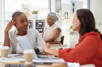 Smiling ambitious african american business woman sitting and working in office. Confident focused ethnic professional sitting behind team of colleagues. Determined to be successful women in business